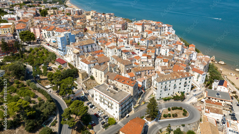 Fototapeta premium Aerial view of the town and the historic center of Rodi Garganico, located in Puglia, Italy, on the coast of the Adriatic Sea. It is a tourist destination in Gargano, in the province of Foggia.