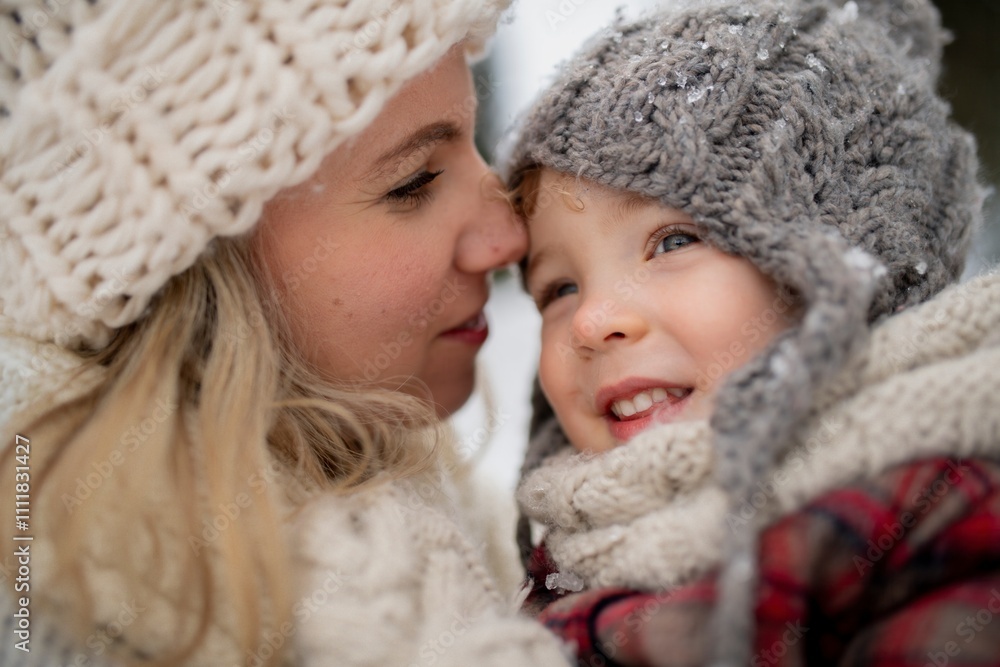 Potrait of mother in the middle of snowy landscape holding daughter in arms. Mom and girl enjoying winter holiday in the mountains. Potrait of mother in the middle of snowy landscape holding daughter in arms. Mom and girl enjoying winter holiday in the mountains.
