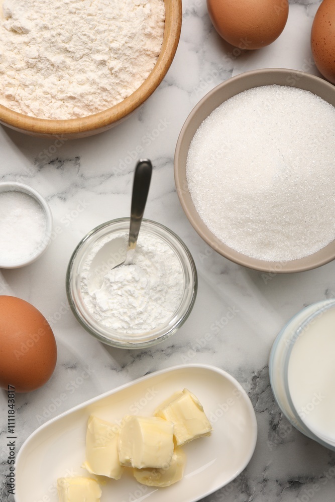 Baking powder and other products on white marble table, flat lay Baking powder and other products on white marble table, flat lay