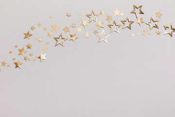 Christmas party background with golden confetti stars. Top view and flat lay.
