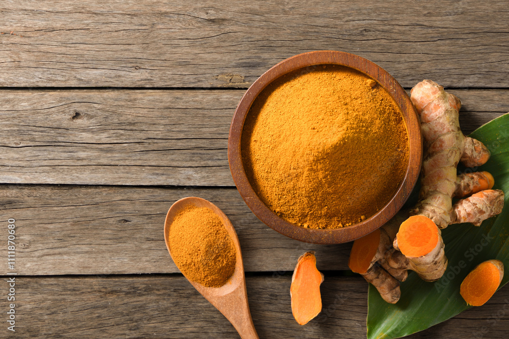 Turmeric (curcumin) powder and fresh rhizome on wooden table. Turmeric (curcumin) powder and fresh rhizome on wooden table.