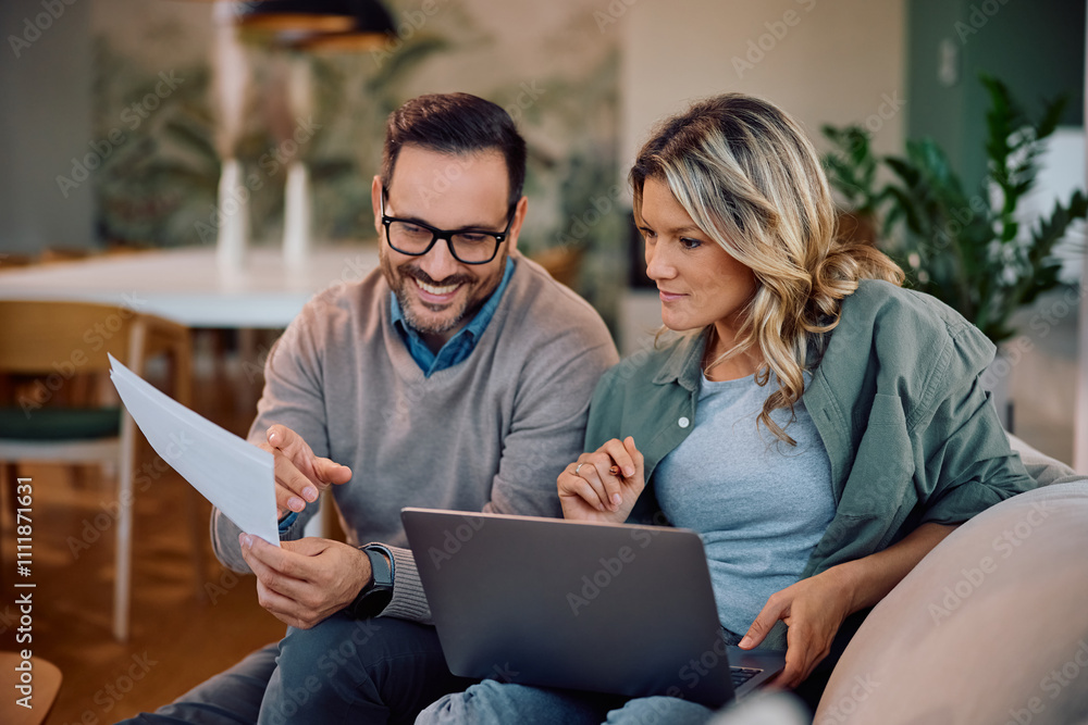 Smiling couple going through their home finances at home. Smiling couple going through their home finances at home.