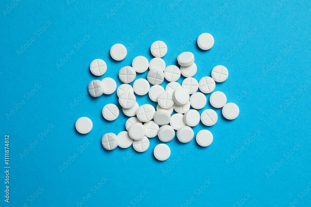 White medicine pills on color background White medicine pills on color background