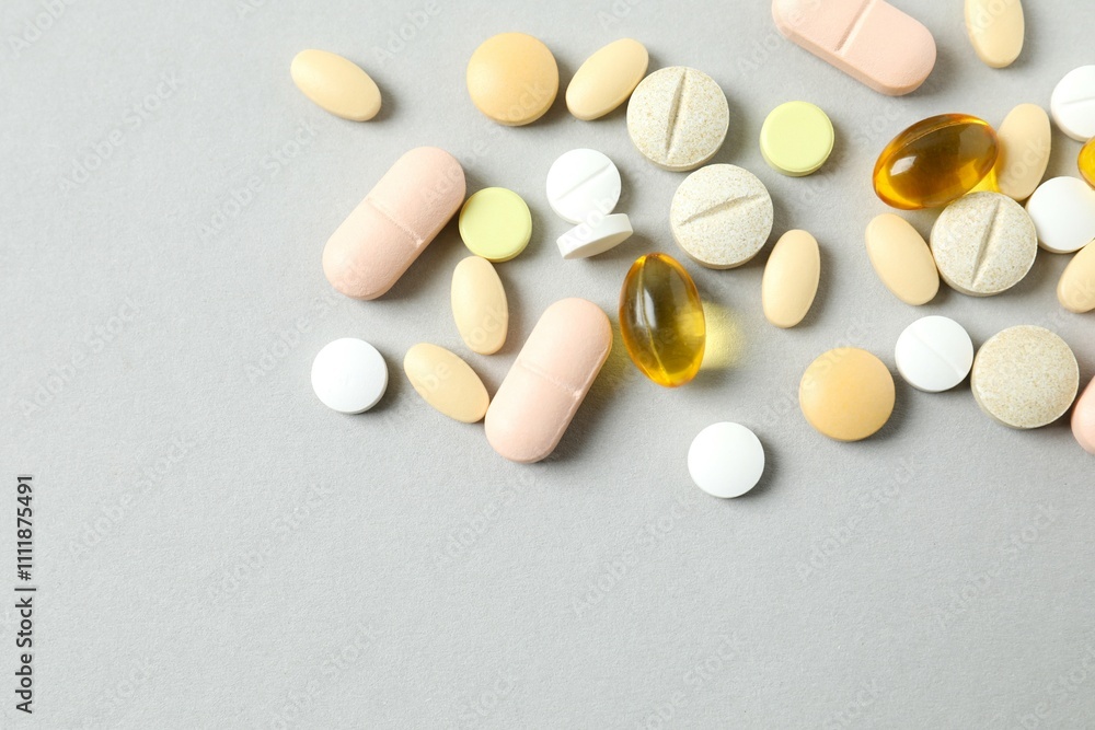 Various medicine pills and capsules on gray background Various medicine pills and capsules on gray background