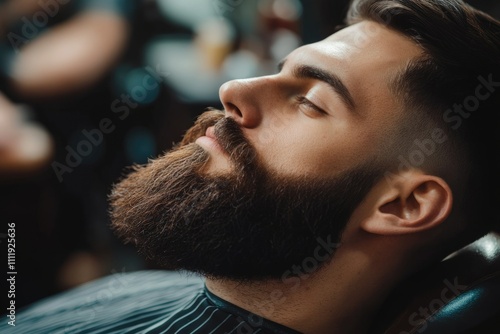 A man with a full beard relaxes in a barber chair  eyes closed  awaiting a beard trim.