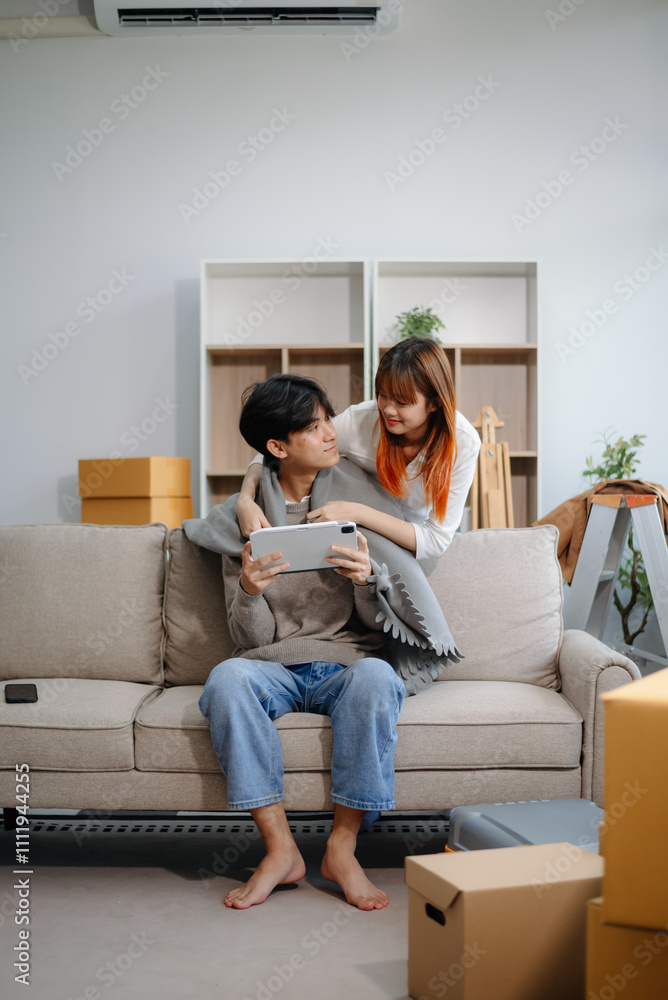 Young couple preparing for a move, packing boxes and a suitcase in a cozy living room. Perfect for themes of relocation Young couple preparing for a move, packing boxes and a suitcase in a cozy living room. Perfect for themes of relocation