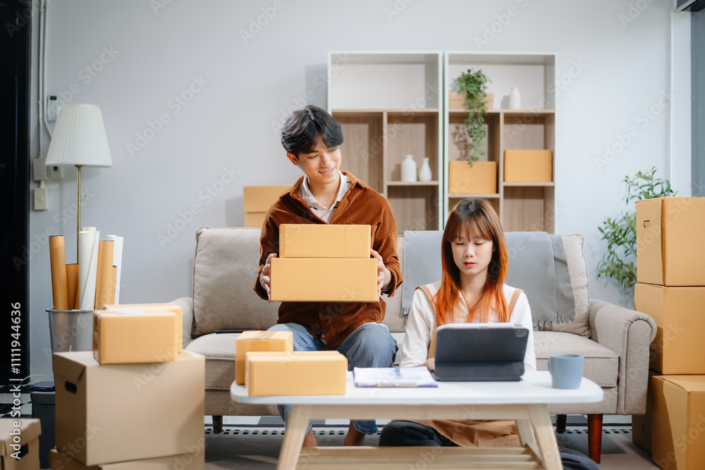 Asian man and woman working at home office, BOX, tablet and laptop online, marketing, packaging, delivery. Asian man and woman working at home office, BOX, tablet and laptop online, marketing, packaging, delivery.
