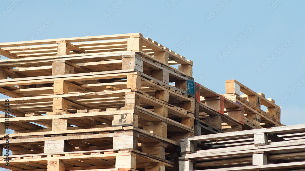 Riga, Latvia – March 14, 2024:pallets stacked against blue sky Riga, Latvia – March 14, 2024:pallets stacked against blue sky