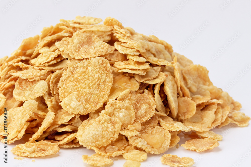 A pile of corn flakes on a white background. A breakfast with a white background and cereal. Breakfast cereal white background handful. A handful of cereal on lifestyle a white background. A pile of corn flakes on a white background. A breakfast with a white background and cereal. Breakfast cereal white background handful. A handful of cereal on lifestyle a white background.