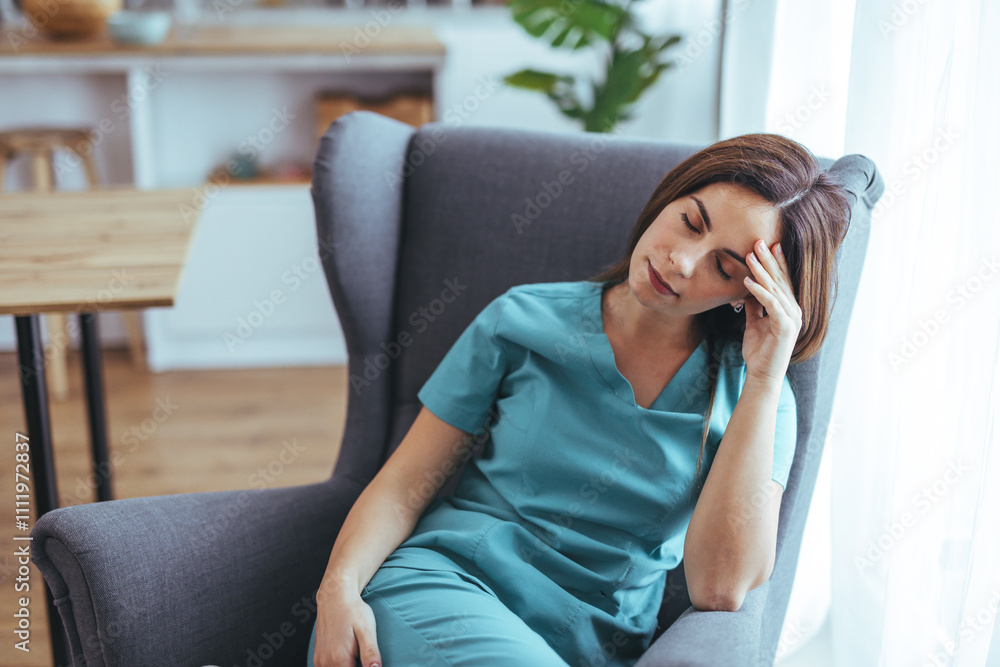 Tired Nurse Relaxing in Armchair After a Long Shift at Home Tired Nurse Relaxing in Armchair After a Long Shift at Home