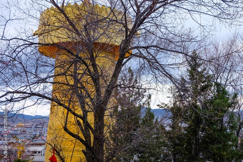 Dafo Temple and its golden World's Largest Prayer Wheel in Guishan park, Shangri-La, China  photo