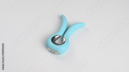 Blue vibrator spinning on white background. 