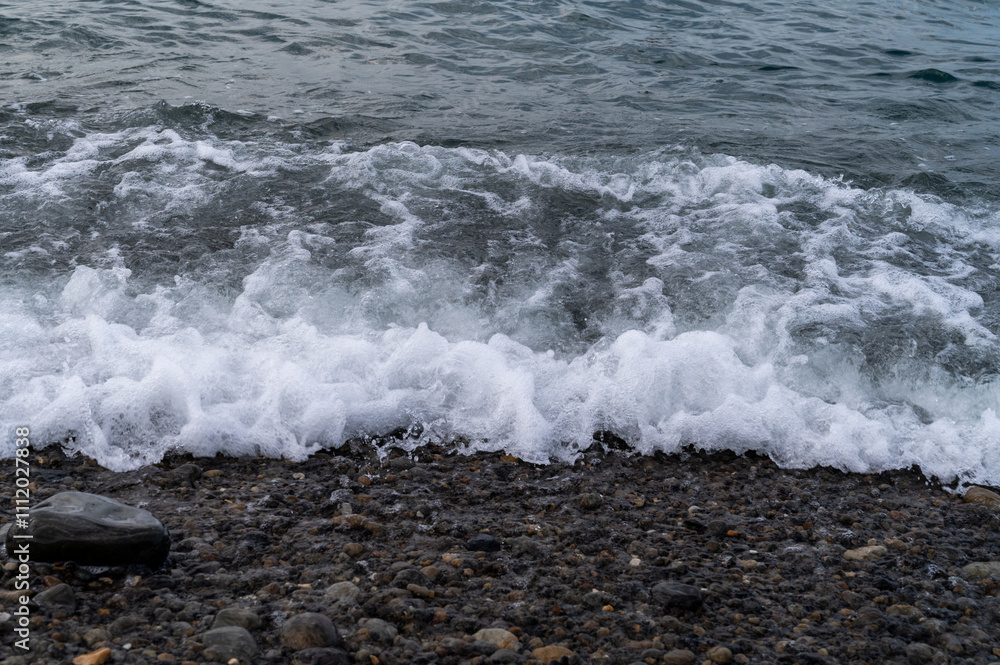 Obraz premium Water sea beach. Wave ocean blue. Stone texture reflection sun. Surface coast pebbles. 