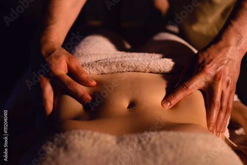 relaxing massage and body shaping massage, lymphatic drainage, manual and aesthetic procedures, hands massaging belly in the spa salon photo