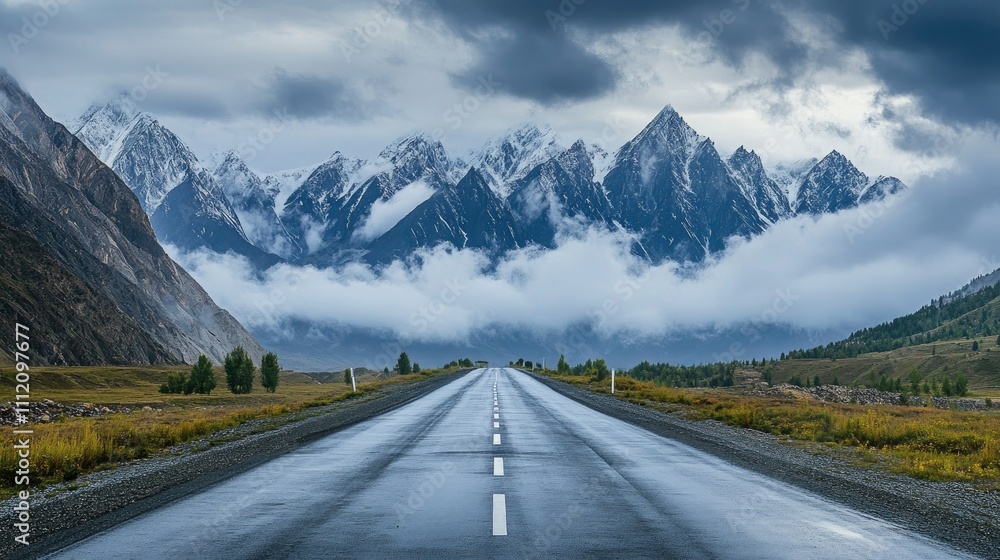 Serene Mountain Road Under Dramatic Cloudy Sky and Majestic Peaks Serene Mountain Road Under Dramatic Cloudy Sky and Majestic Peaks