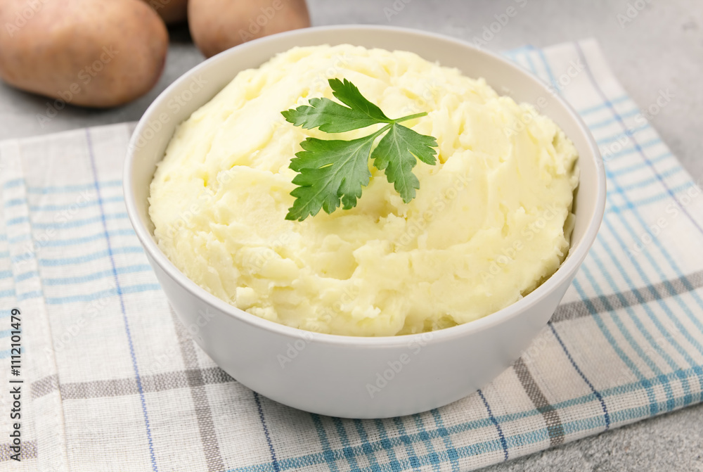 Mashed potatoes in white bowl on grey concrete background. Healthy food Mashed potatoes in white bowl on grey concrete background. Healthy food