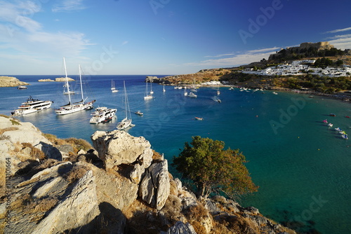 paradisiac greek beach full of boats and yatchs photo