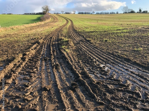 Muddy field with big tyre tracks on a sunny day in November, North Yorkshire, England , United Kingdom photo