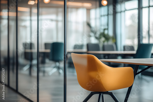 Modern office interior with stylish yellow chair and glass partitions for creative workspace photo