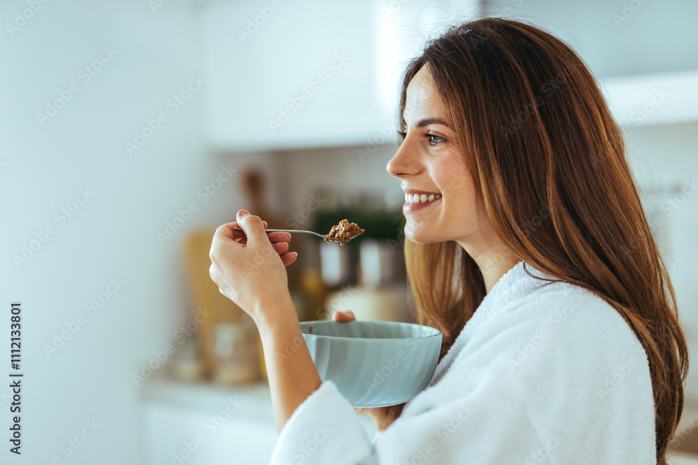 Smiling Woman Enjoying A Healthy Breakfast In Her Cozy Kitchen Smiling Woman Enjoying A Healthy Breakfast In Her Cozy Kitchen