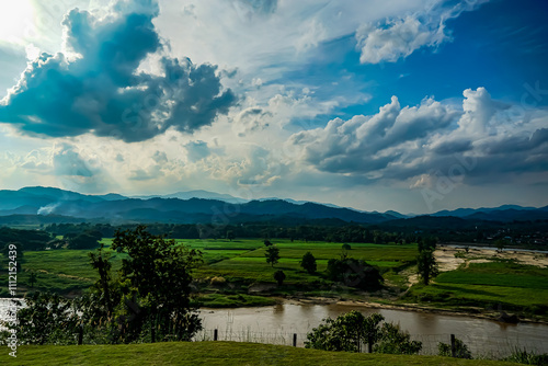 Wallpaper Mural Serene landscape view of lush green fields and rolling hills under dramatic cloudy sky rural area nature photography scenic perspective Torontodigital.ca