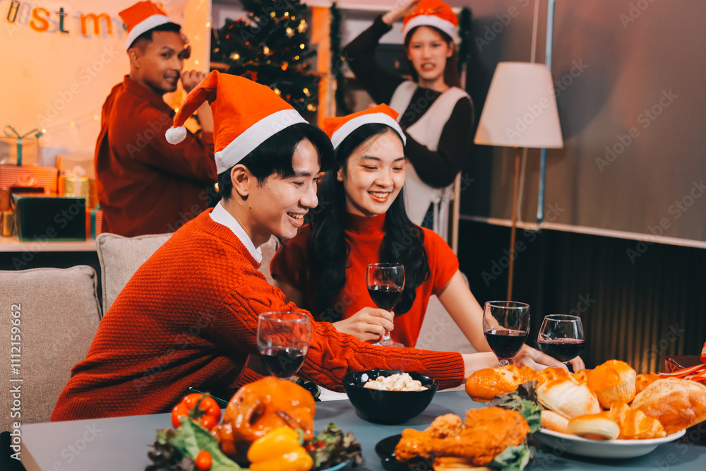 Group of young Asian man and women as friends having fun at a New Year's celebration, holding gift boxes standing by Christmas tree decoration, midnight countdown Party at home with holiday season. Group of young Asian man and women as friends having fun at a New Year's celebration, holding gift boxes standing by Christmas tree decoration, midnight countdown Party at home with holiday season.
