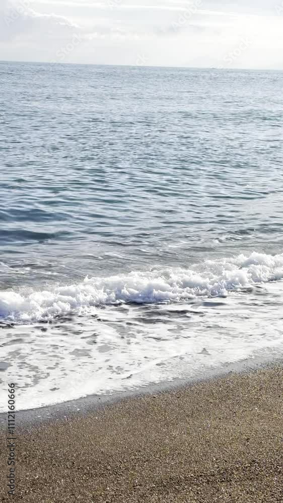 The waves hit the shore at sunset