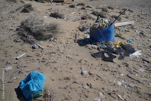 massive pile of trash on a sand beach  photo