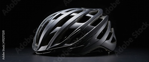 Sleek black bicycle helmet showcased on a dark background, emphasizing safety and style photo