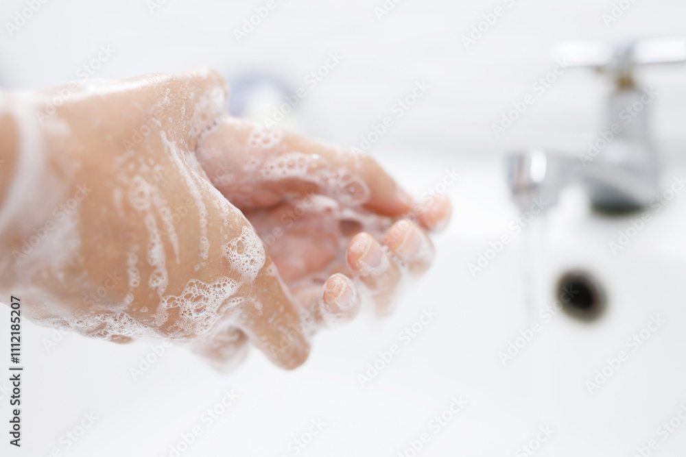Fototapeta premium Hygiene. Cleaning Hands. Washing hands with soap under the faucet with water