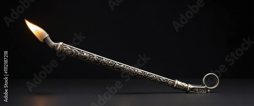 Elegant candle snuffer on a black background, perfect for home decor and relaxation photo