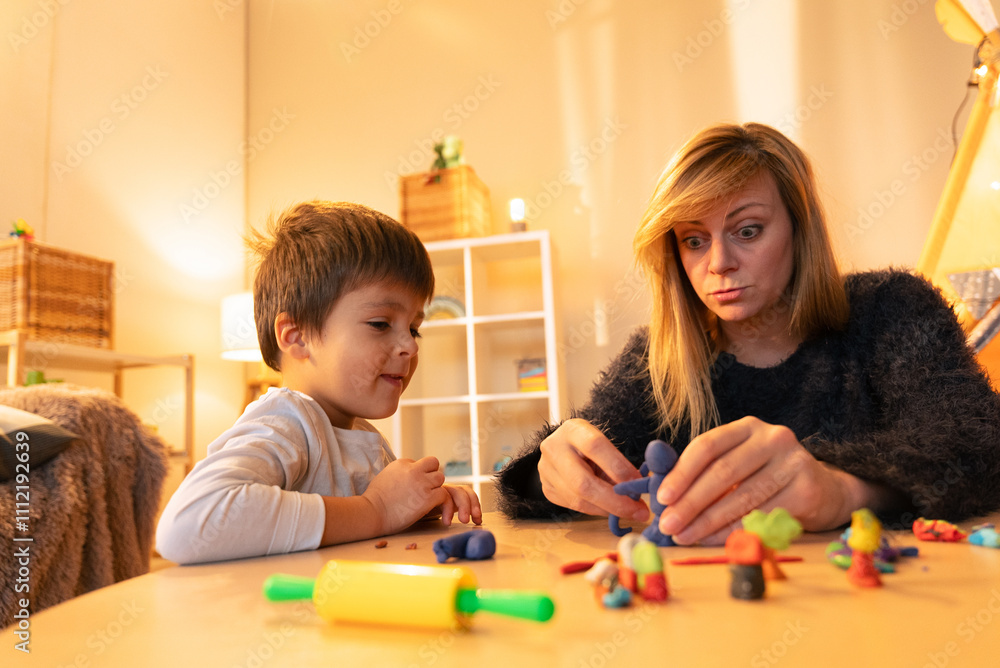 Mother and son making clay figures at home, enjoying creative time together Mother and son making clay figures at home, enjoying creative time together