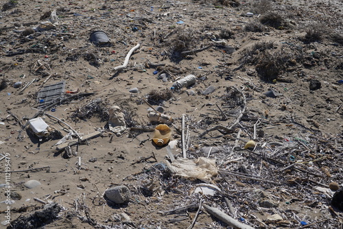 spread out trash on a sand beach photo