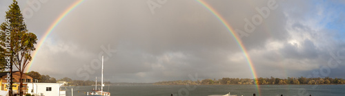 rainbow glowing in morning light over Hastings River in Port Macquarie