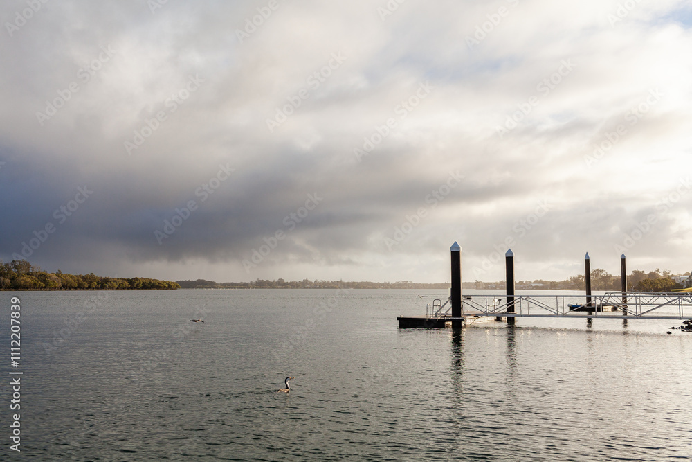 pontoon on Hastings River in Port Macquarie in morning light with rainy sky pontoon on Hastings River in Port Macquarie in morning light with rainy sky