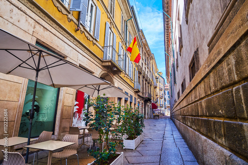 Obraz na płótnie Narrow Via Zebedia street with restaurant's outdoor seating, Milan, Italy w salonie
