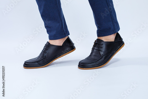 A man is wearing classic black shoes made of natural leather on lace, shoes for men under business style photo