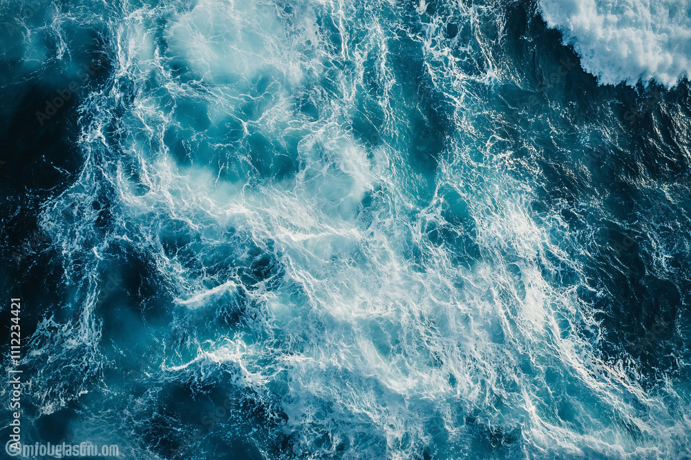 A dynamic aerial view of ocean waves with vibrant blue and white foam creating an energetic and textured water surface
A dynamic aerial view of ocean waves with vibrant blue and white foam creating an energetic and textured water surface