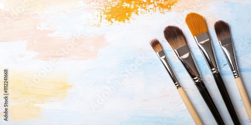 Artistic paint brushes arranged on a colorful background for creative projects. photo