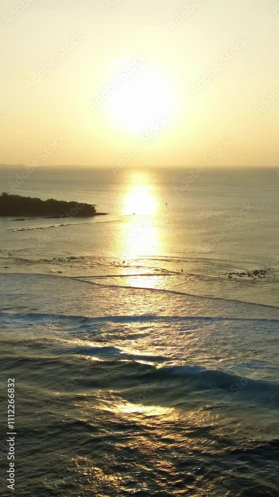 Drone view at a beautiful sunset over the ocean water of the Maldives. Drone view at a beautiful sunset over the ocean water of the Maldives.