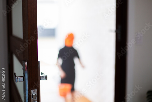 out of focus trick or treater at a front door on Halloween photo