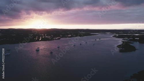 Aerial of Sunset Over Calm Waters: Swamp with Boats and Dramatic Clouds