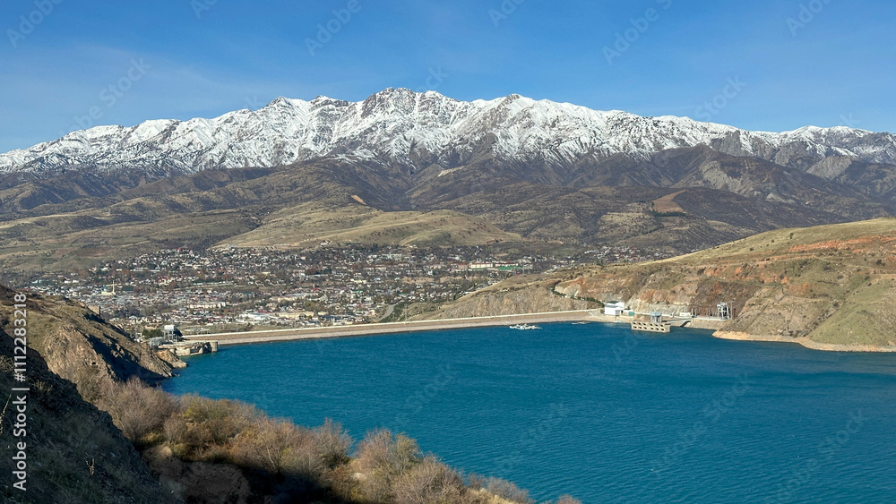 reservoir in the mountains with snowy peaks reservoir in the mountains with snowy peaks