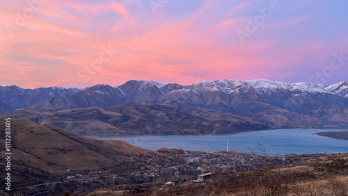 Snowy peaks mountains at the sunset