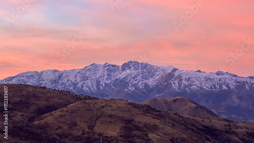 Snowy peaks mountains at the sunset