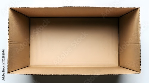 A brown corrugated cardboard box photographed from above, showing clean interior and minimal packaging details with soft shadows in professional studio lighting.