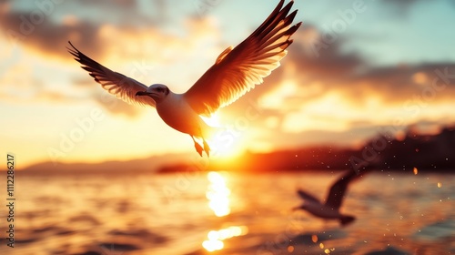 A seagull elegantly soars over a calm ocean, silhouetted against a breathtaking golden sunset sky, capturing the essence of freedom and tranquility in nature. photo