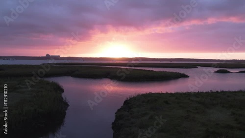 Aerial Sunset with Dramatic Sky Over Water Channels with Boats Docked