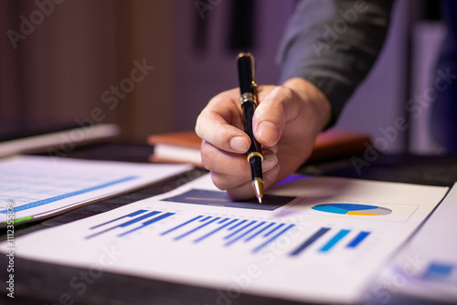 Accountants working on financial investments on calculators, calculating, analyzing business and marketing growth on graphs of various financial documents.