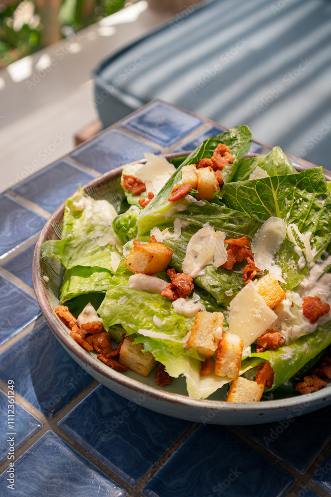 Close up shot of caesar salad with crispy bacon and parmesan cheese Close up shot of caesar salad with crispy bacon and parmesan cheese